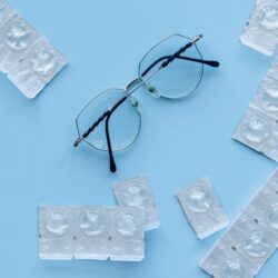black framed eyeglasses on blue table