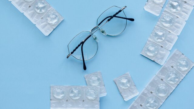 black framed eyeglasses on blue table