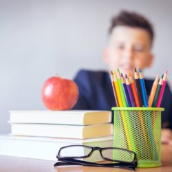 boy looking on a tidied desk