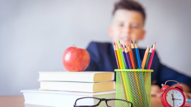 boy looking on a tidied desk
