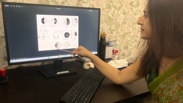 Dr Shibal Bhartiya reviewing neurological visual field defects on a perimetry report with a patient in Gurgaon